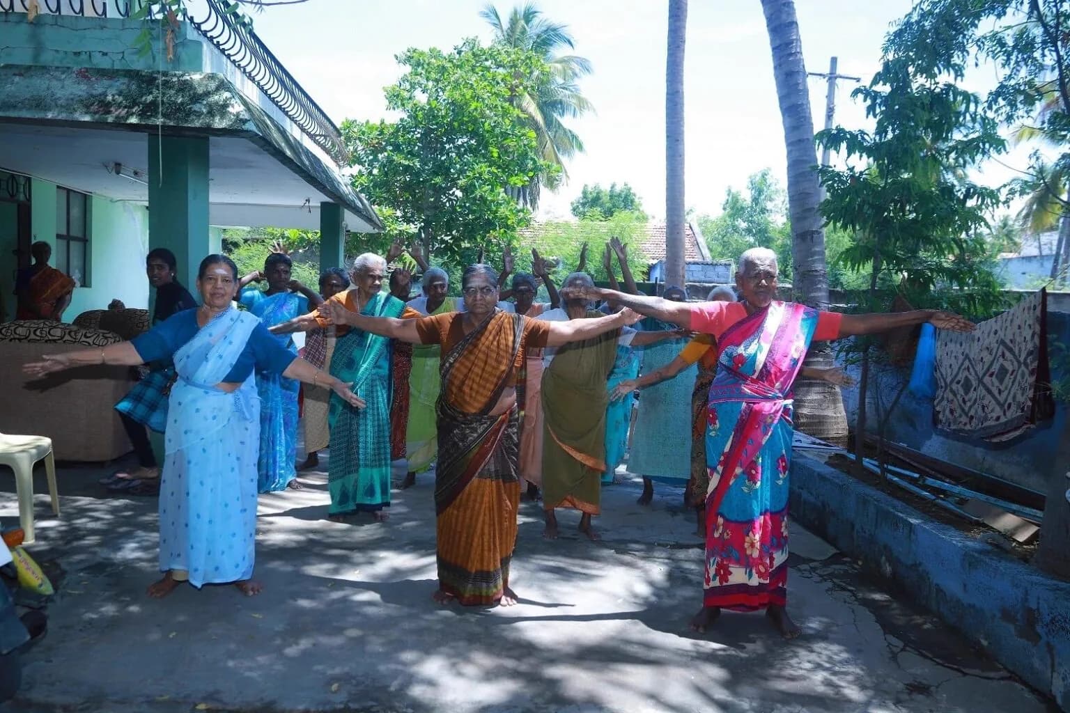REAL Trust residents and team at the entrance of the home